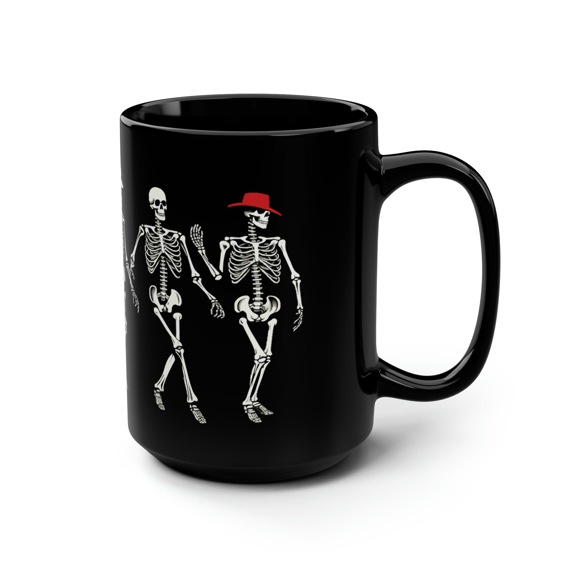 A side view of a black coffee mug with an image of dancing skeletons in hats printed on it.